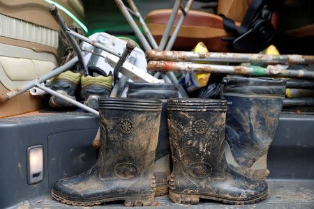 Muddy boots are seen as journalists leave the site of the Tham Luang cave complex after Thailand's government instructed the media to move out urgently, in the northern province of Chiang Rai, Thailand, July 8, 2018. REUTERS/Soe Zeya Tun