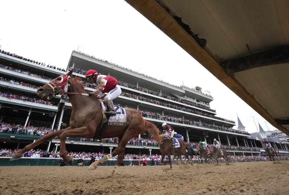 Rich Strike, right, with jockey Sonny Leon aboard, wins the Kentucky Derby. May 7, 2022