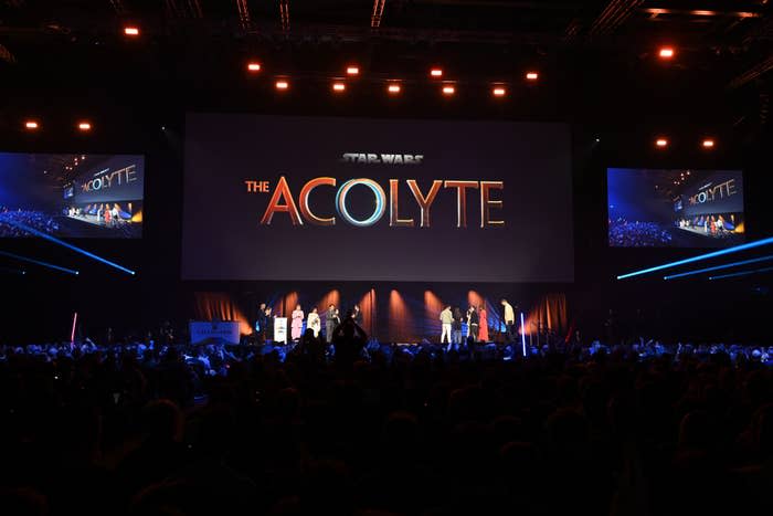 Stage event reveal of 'The Acolyte' with people on stage and audience watching