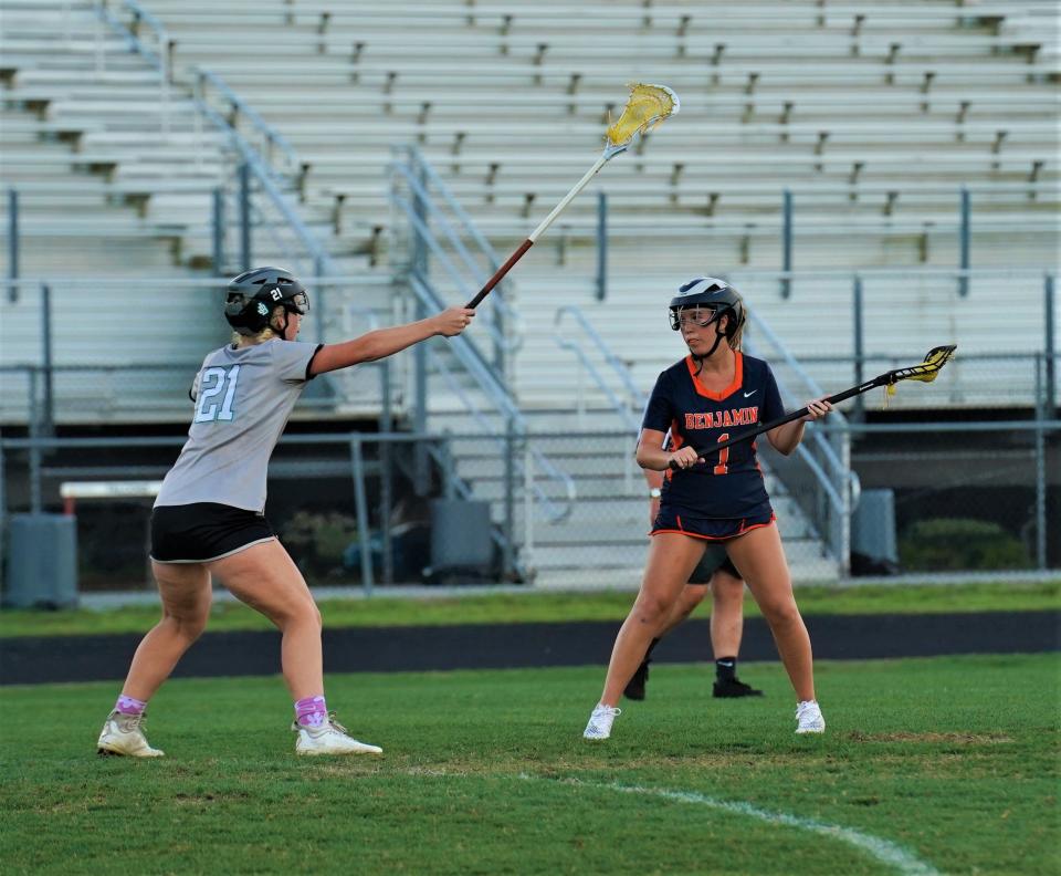 Benjamin's Ava Schulties is defended by Jensen Beach's Tatum Swope during the District 13-1A girls lacrosse championship game on Friday, April 14, 2023 in Jensen Beach. Benjamin won 7-6.
