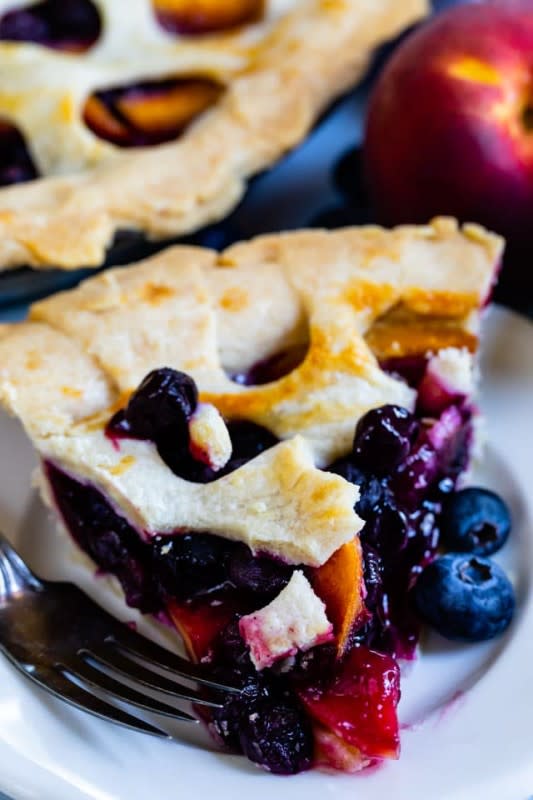 <p>Crazy For Crust</p><p>Peaches and blueberries are a perfect match and every bite of this pie will prove it<strong>.</strong></p><p><strong>Get the recipe:<a href="https://www.crazyforcrust.com/peach-blueberry-pie/" rel="nofollow noopener" target="_blank" data-ylk="slk:Peach Blueberry Pie;elm:context_link;itc:0;sec:content-canvas" class="link "> Peach Blueberry Pie</a></strong></p>