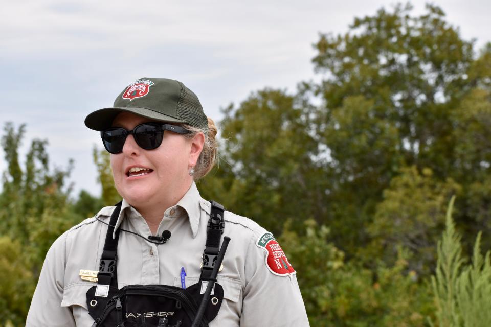 Carrie McCullen, public information officer with the North Carolina Forest Service, gives an update at the scene in the Holly Shelter Game Land on Aug. 11, 2022, in Pender County.