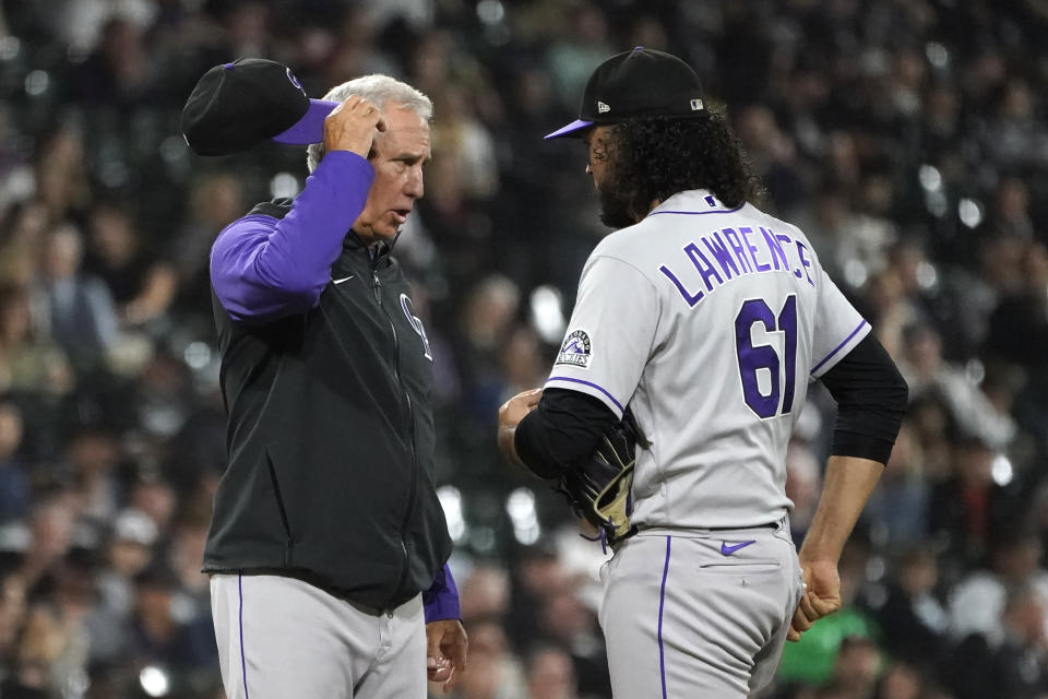 Colorado Rockies manager Bud Black talks with relief pitcher Justin Lawrence during the seventh inning of the team's baseball game against the Chicago White Sox on Tuesday, Sept. 13, 2022, in Chicago. (AP Photo/Charles Rex Arbogast)