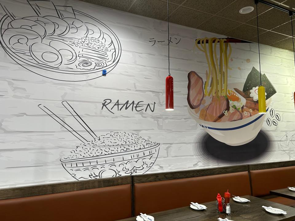 Wall art at Noodle King captures the fun of eating ramen and pho.