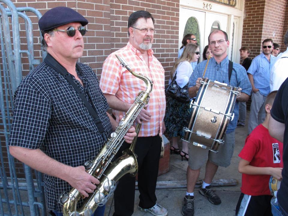 Saxophonist Mike Nelson, left, trumpeter Don Chandler, center, and drummer Carson Lamm prepare to participate in a funeral parade down Memphis' Beale Street honoring late soul bassist Donald "Duck" Dunn on Wednesday, May 23, 2012 in Memphis, Tenn. More than 100 fans walked and danced down the Memphis drag during the New Orleans-style parade to remember Dunn, who died May 13 at age 70 while on tour in Japan. (AP Photo/Adrian Sainz)