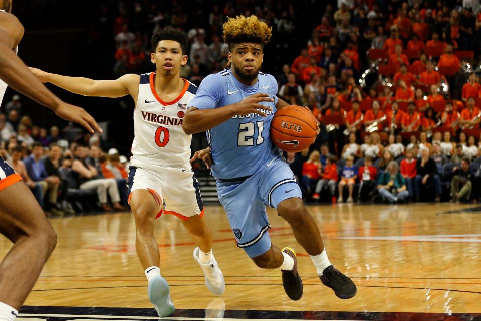 Columbia Lions guard Mike Smith drives to the basket past Virginia Cavaliers guard Kihei Clark.