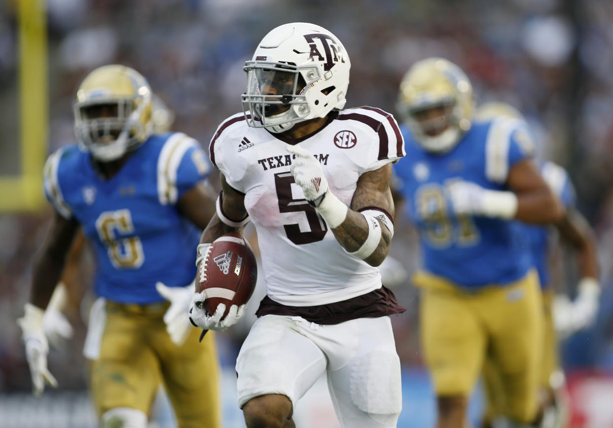 Texas A&M running back Trayveon Williams runs for a 61-yard touchdown against UCLA during the first half of an NCAA college football game, Sunday, Sept. 3, 2017, in Pasadena, Calif. (AP Photo/Danny Moloshok)