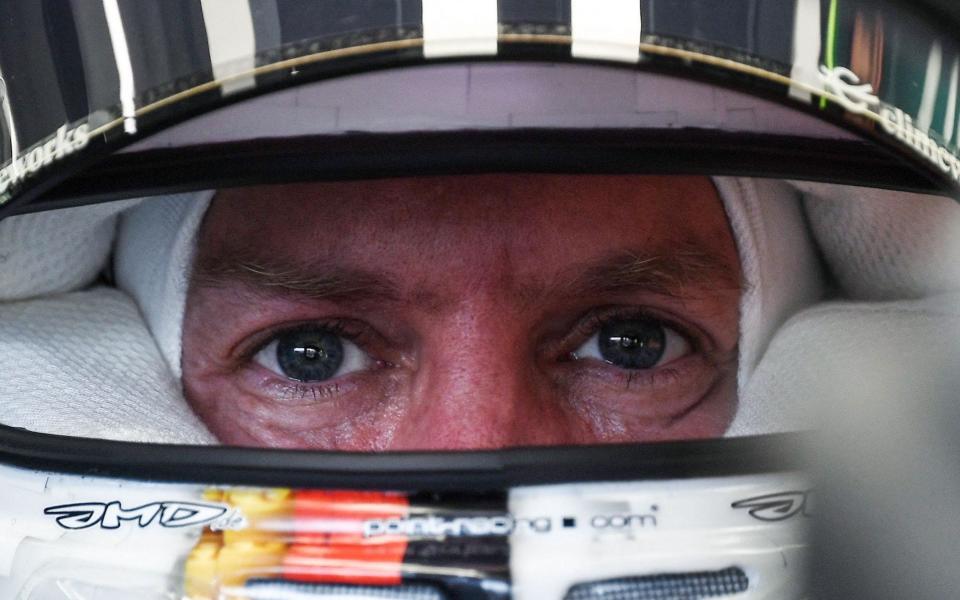 Aston Martin's German driver Sebastian Vettel sits in his car in the pit lane during the first practice session ahead of the Formula One Hungarian Grand Prix - Ferenc Isza