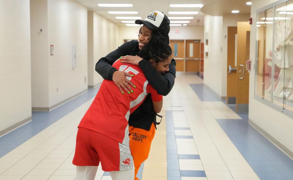 Connecticut Sun's Ty Harris hugs Fishers Tigers Talia Harris (15) on Tuesday, Jan. 16, 2024, during the game at Fishers High School in Fishers. The Fishers Tigers defeated the Carmel Greyhounds, 44-37.