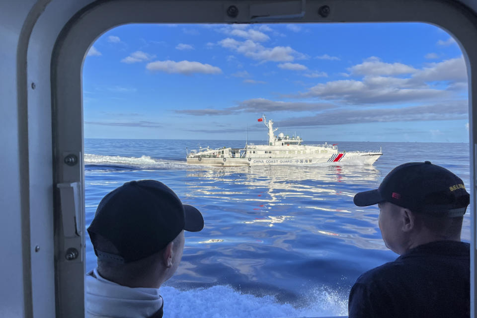 A Chinese coast guard vessel maneuvers beside the Philippine coast guard ship BRP Cabra as they approach Second Thomas Shoal, locally known as Ayungin Shoal, during a resupply mission at the disputed South China Sea on Friday Nov. 10, 2023. (AP Photo/Jim Gomez)