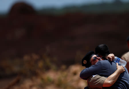 Rescue workers react as they attend a mass for victims of a collapsed tailings dam owned by Brazilian mining company Vale SA, in Brumadinho, Brazil February 1, 2019. REUTERS/Adriano Machado