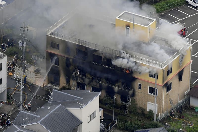 FILE PHOTO : An aerial view shows firefighters battling fires at the site where a man started a fire after spraying a liquid at a three-story studio of Kyoto Animation Co. in Kyoto, western Japan, in this photo taken by Kyodo