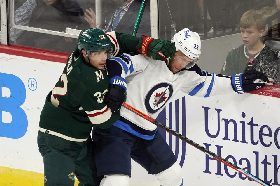 Minnesota Wild's Kevin Fiala (22) defends against Winnipeg Jets' Paul Stastny (25) during the first period of an NHL hockey game Tuesday, Oct. 19, 2021, in St. Paul, Minn. (AP Photo/Jim Mone)