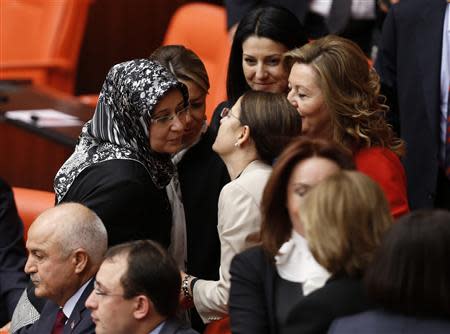 Turkey's ruling AK Party (AKP) lawmaker Gulay Samanci is congratulated by her party's lawmakers as she attends the general assembly wearing her headscarf at the Turkish Parliament in Ankara October 31, 2013. REUTERS/Umit Bektas