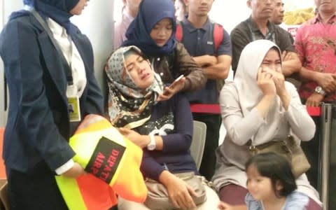 Relatives of passengers of Lion Air flight JT610 that crashed into the sea, cry at Depati Amir airport in Pangkal Pinang - Credit: Reuters