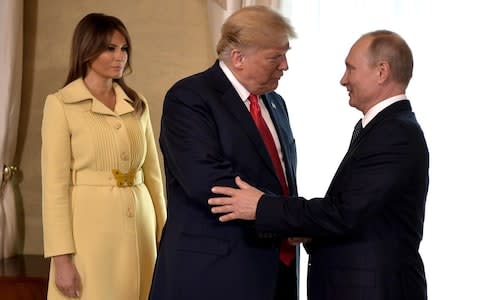 Donald Trump and Vladimir Putin embrace for a second time - Credit: Andalou