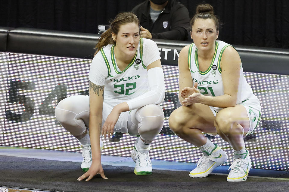 EUGENE, OREGON - FEBRUARY 28: Sedona Prince #32 and Erin Boley #21 of the Oregon Ducks wait to enter the game during the first half against the Oregon State Beavers at Matthew Knight Arena on February 28, 2021 in Eugene, Oregon. (Photo by Soobum Im/Getty Images)