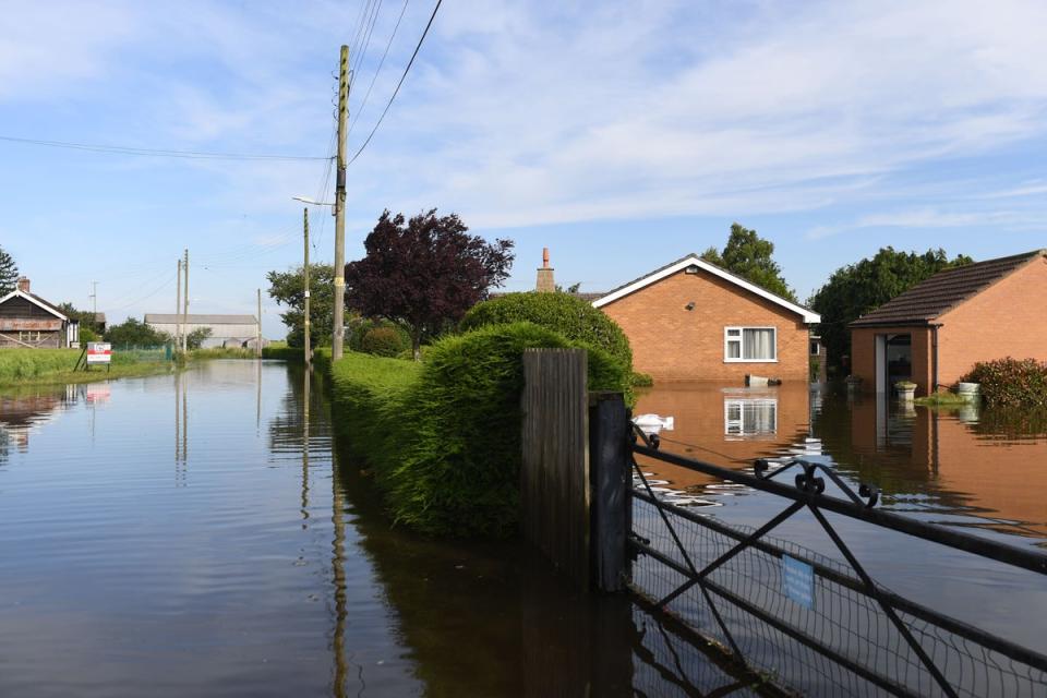 Houses surrounded by flood water on Matt Pit Lane in Wainfleet All Saints in Lincolnshire after the town had to deal with more than two months of rain in just two days (PA Archive)