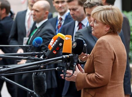 German Chancellor Angela Merkel talks to journalists as she arrives at a European Union leaders extraordinary summit on the migrant crisis, in Brussels, Belgium September 23, 2015. REUTERS/Francois Lenoir