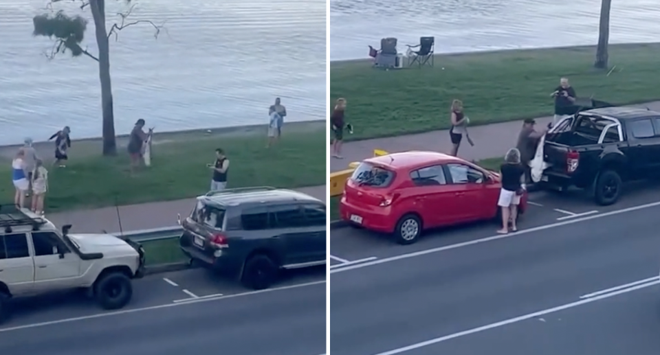 The man carries the shark with both hands in front of him (left) and chucks the shark into the ute (right).