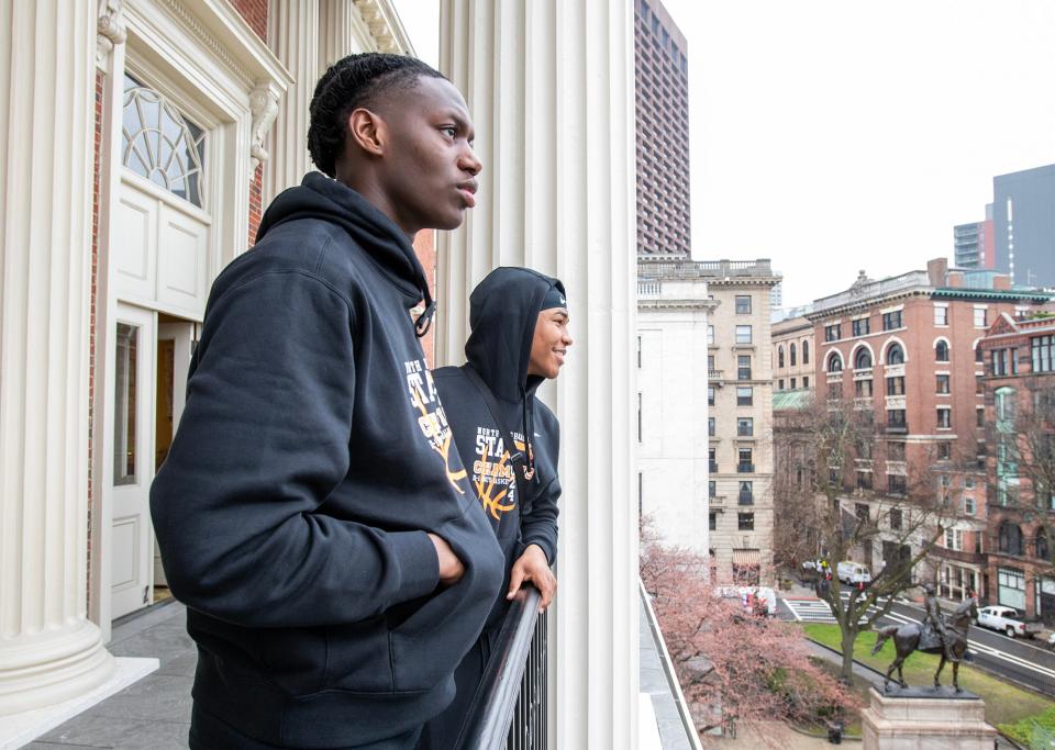 North High School basketball players Joe Okla, left, and Amaren Minor look out over the Boston Common from a balcony off the Senate Chamber during a visit to the Massachusetts State House Thursday.