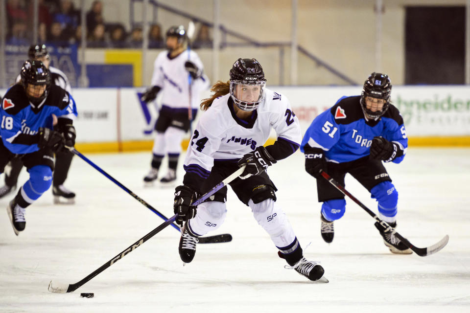 Minnesota forward Abby Boreen (24) skates with the puck ahead of Toronto forward Victoria Bach (51) during the first period of a PWHL hockey game in Toronto, Ontario, Saturday, Feb. 3, 2024. (Christopher Katsarov/The Canadian Press via AP)