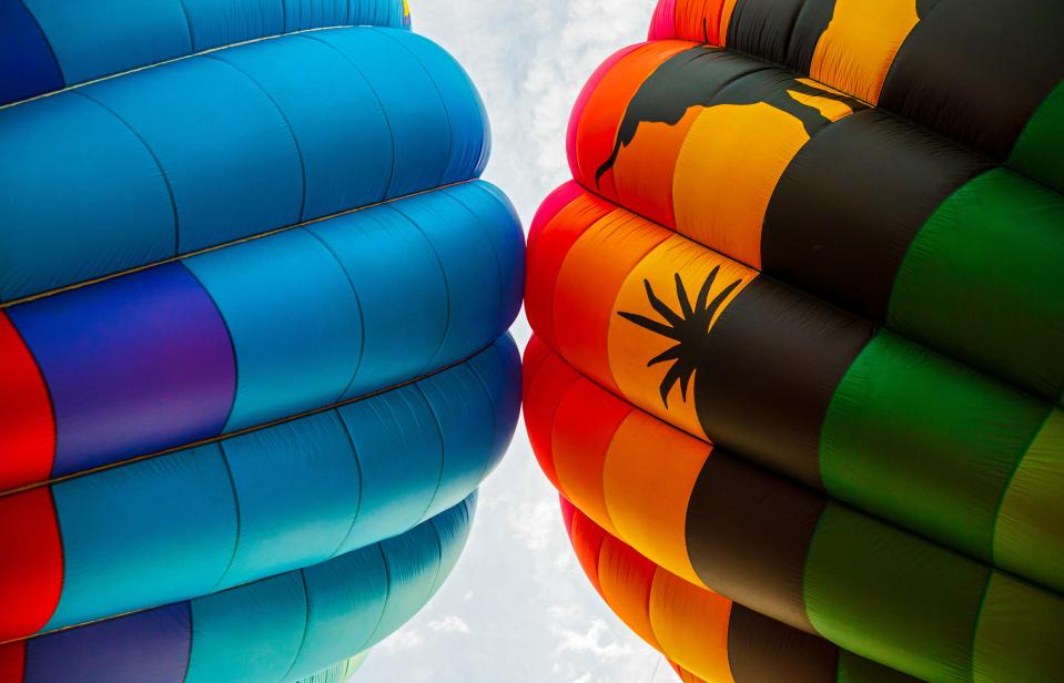 The colors of hot air balloons fill the sky as crews work to inflate the balloons during the morning balloon glow and flights for the FireLake Fireflight Balloon Fest in Shawnee Okla. on Friday, Aug. 13, 2021.