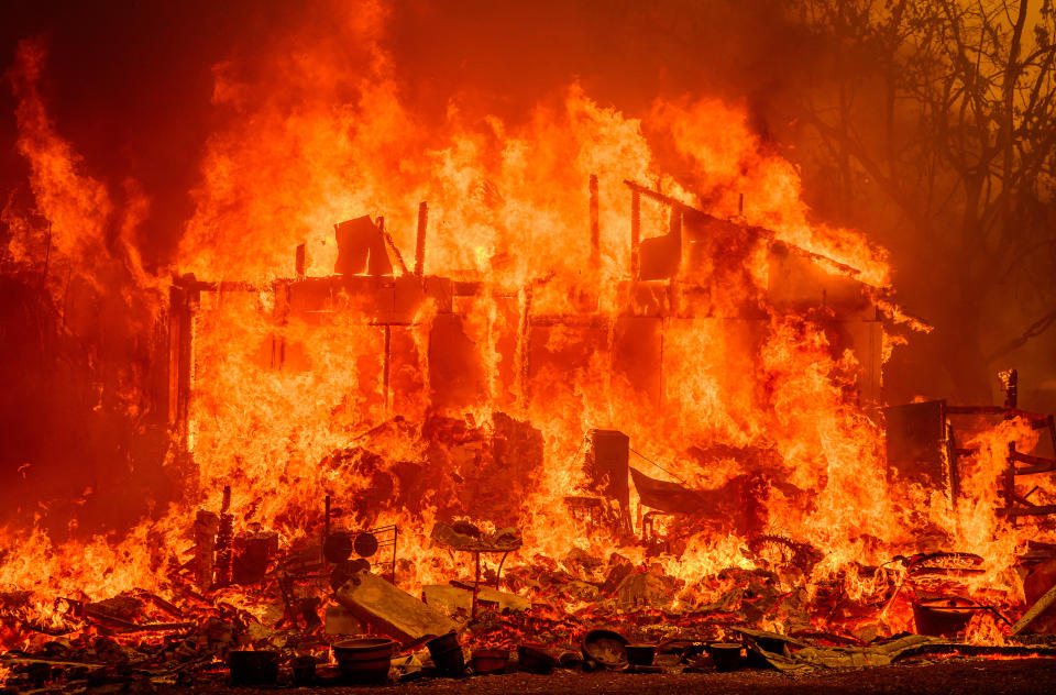 Flames engulf a home during the Thompson fire in Oroville, California on July 2, 2024. A heatwave is sending temperatures soaring resulting in red flag fire warnings throughout the state. / Credit: JOSH EDELSON/AFP via Getty Images