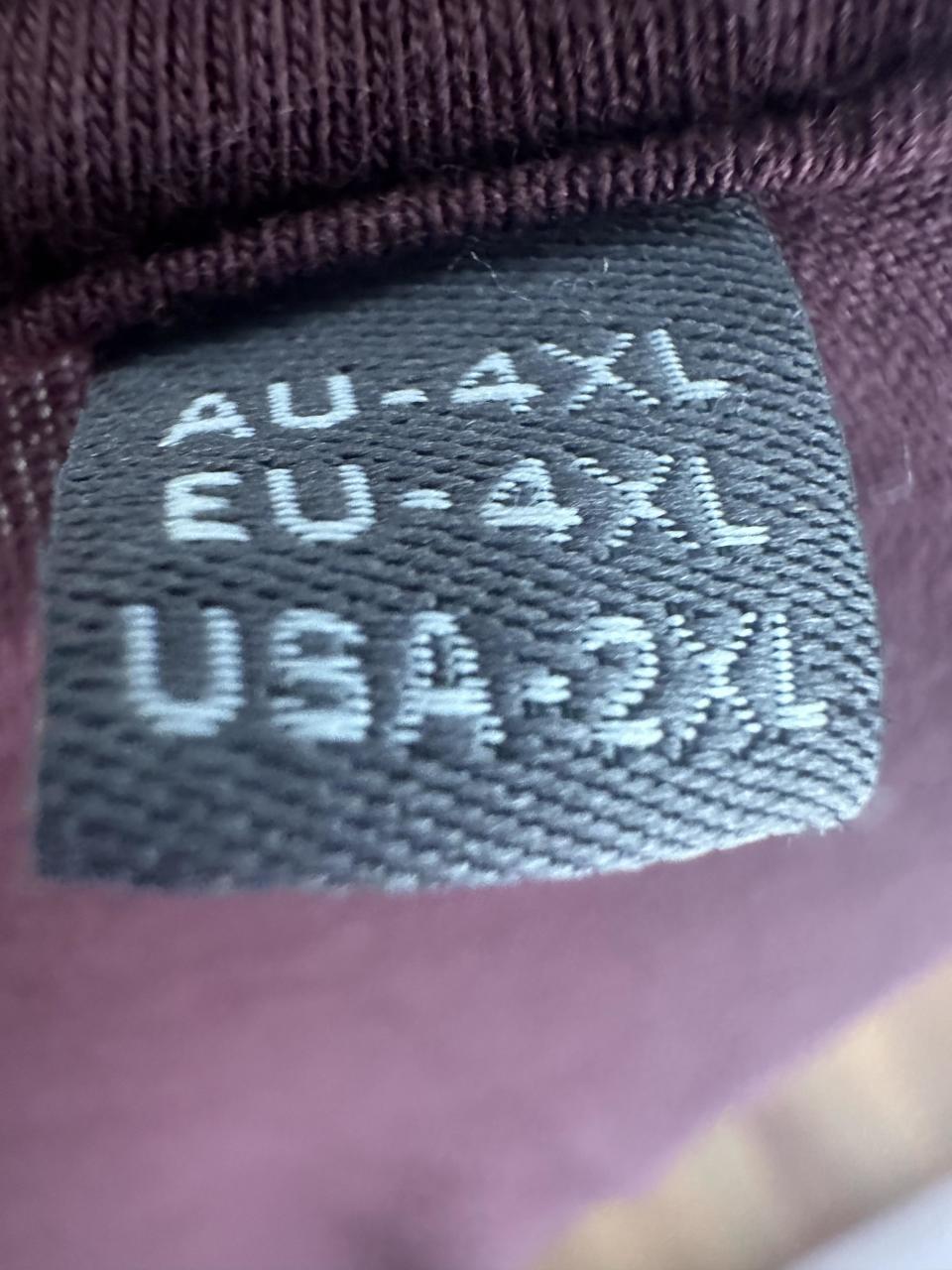 Clothing label indicating sizes: AU-4XL, EU-4XL, USA-2XL