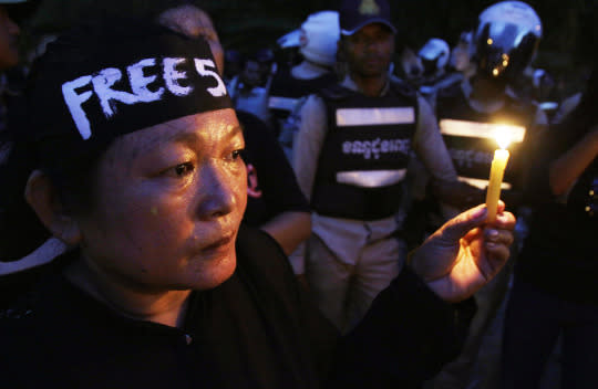 <p>An activist holds a candle during a protest in Phnom Penh, Cambodia, on May 23, 2016, against the detention of human rights activists who said a woman’s affair with a government official had been covered up. (Heng Sinith/AP) </p>