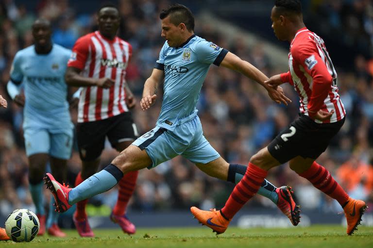 Manchester City's Argentinian striker Sergio Aguero (2R) takes a shot during the English Premier League football match between Manchester City and Southampton in Manchester, England on May 24, 2015