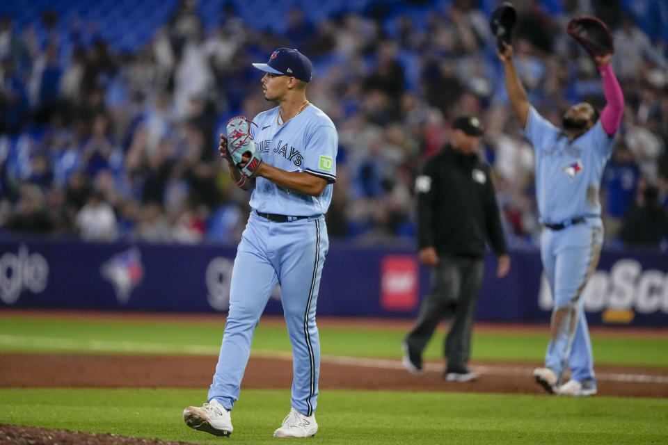 Toronto Blue Jays relief pitcher Jordan Hicks, left, looks on after defeating the Washington Nationals in baseball game action in Toronto, Monday, Aug. 28, 2023. (Andrew Lahodynskyj/The Canadian Press via AP)