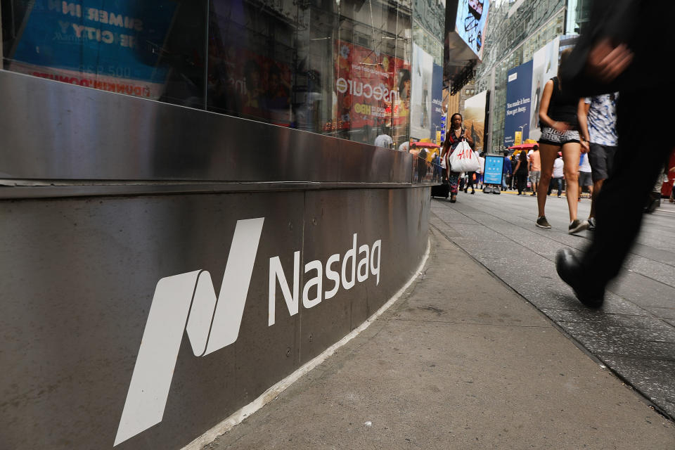 NEW YORK, NY - JULY 30:  People walk by the Nasdaq MarketSite in Times Square on July 30, 2018 in New York City. As technology stocks continued their slide on Monday, the Nasdaq Composite dropped 1.1 percent in afternoon trading with shares of Facebook, Netflix, Amazon and Google-parent Alphabet all declining.  (Photo by Spencer Platt/Getty Images)