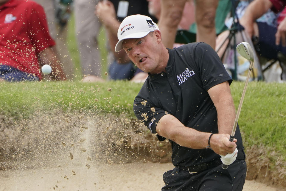 Alex Cejka hits out of the sand on the 16th green in the final round of the Senior PGA Championship golf tournament Sunday, May 30, 2021, in Tulsa, Okla. (AP Photo/Sue Ogrocki)