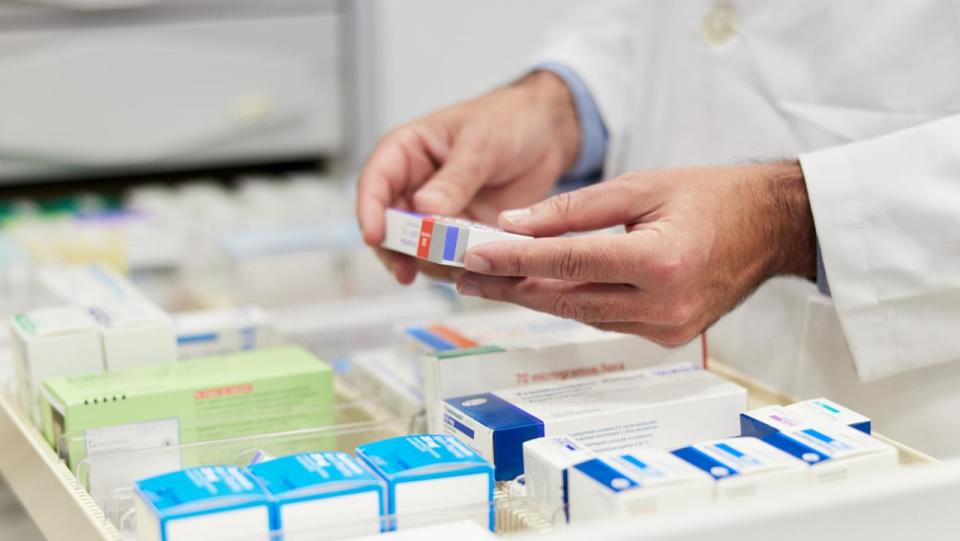 Cloe-up view of a pharmacist hands holding merchandise.