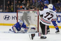 New York Rangers goaltender Alexandar Georgiev (40) makes a save against Chicago Blackhawks center Kirby Dach (77) during the second period of an NHL hockey game Saturday, Dec. 4, 2021, at Madison Square Garden in New York. (AP Photo/Mary Altaffer)