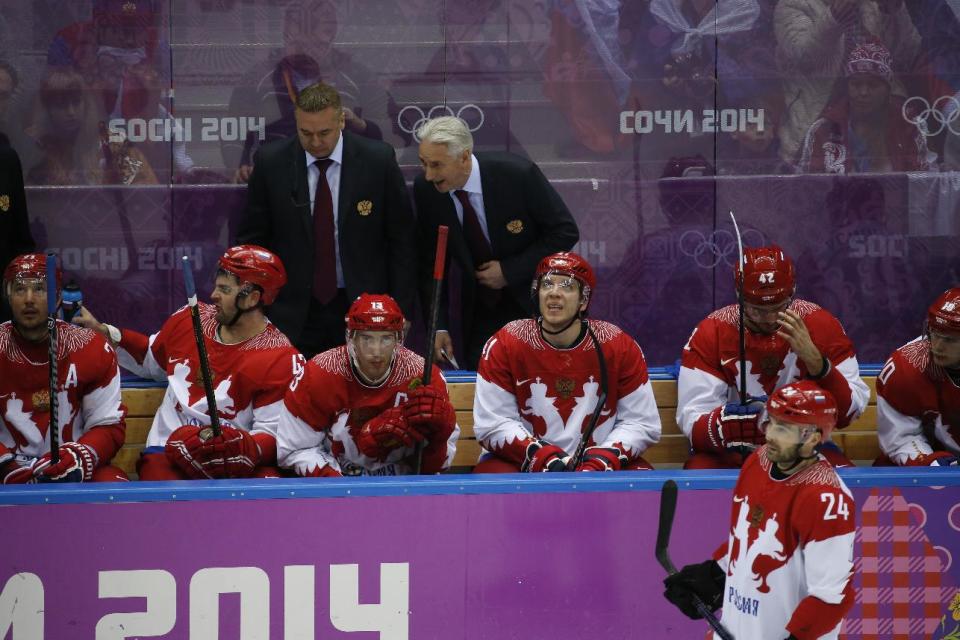 Russian head coach Zinetula Bilyaletdinov talks to players on the bench in the third period of a men's quarterfinal ice hockey game against Finland at the 2014 Winter Olympics, Wednesday, Feb. 19, 2014, in Sochi, Russia. (AP Photo/Mark Humphrey)