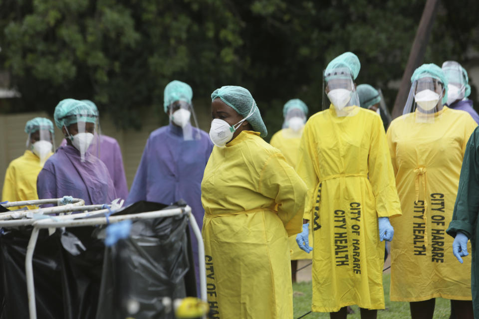 Health workers are sanitized at local hospital where China's Sinopharm vaccine is being administered at a local hospital in Harare, Thursday, Feb, 18, 202. Zimbabwean Deputy President Constantino Chiwenga became the first person in the country to receive the jab marking the first phase of the countrys vaccination campaign.(AP Photo/Tsvangirayi Mukwazhi)