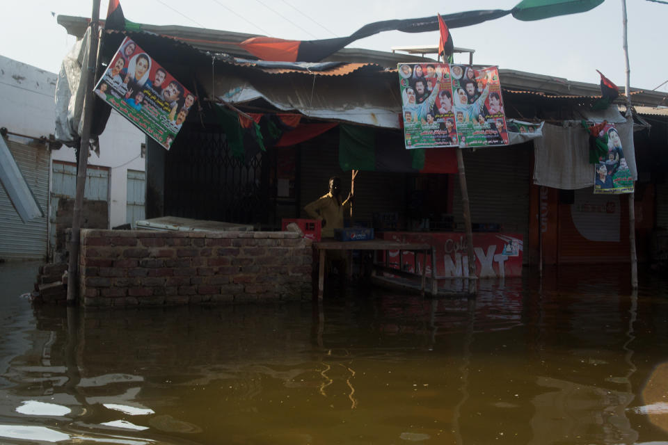 A shopkeeper in Hayat Khaskheli, Jhuddo, alongside his inundated shop, Sept. 9.<span class="copyright">Hassaan Gondal for TIME</span>