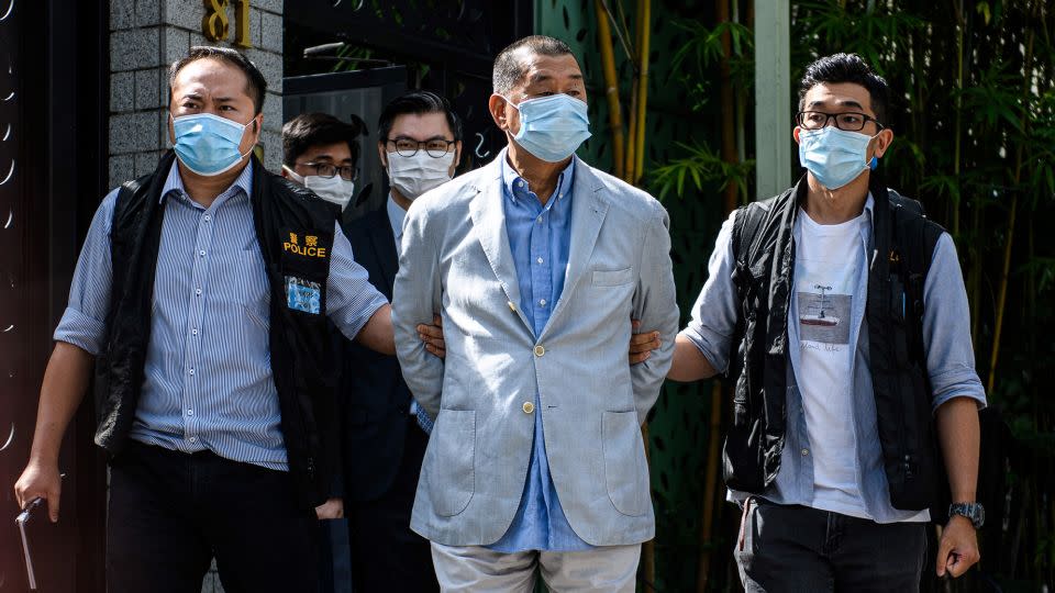 Police lead Hong Kong pro-democracy publisher Jimmy Lai away from his home after he was arrested under the national security law on August 10, 2020. - Vernon Yuen/AFP/Getty Images