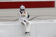 Kyle Busch sits on the pit wall after finishing second to Chase Briscoe in the NASCAR Xfinity series auto race Thursday, May 21, 2020, in Darlington, S.C. (AP Photo/Brynn Anderson)