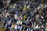 Delegates wearing a protective face masks to help curb the spread of the coronavirus attend an Afghan Loya Jirga meeting in Kabul, Afghanistan, Friday, Aug. 7, 2020. The traditional council opened Friday in the Afghan capital to decide the release of a final 400 Taliban - the last hurdle to the start of negotiations between Kabul’s political leadership and the Taliban in keeping with a peace deal the United States signed with the insurgent movement in February. (AP Photo/Rahmat Gul)