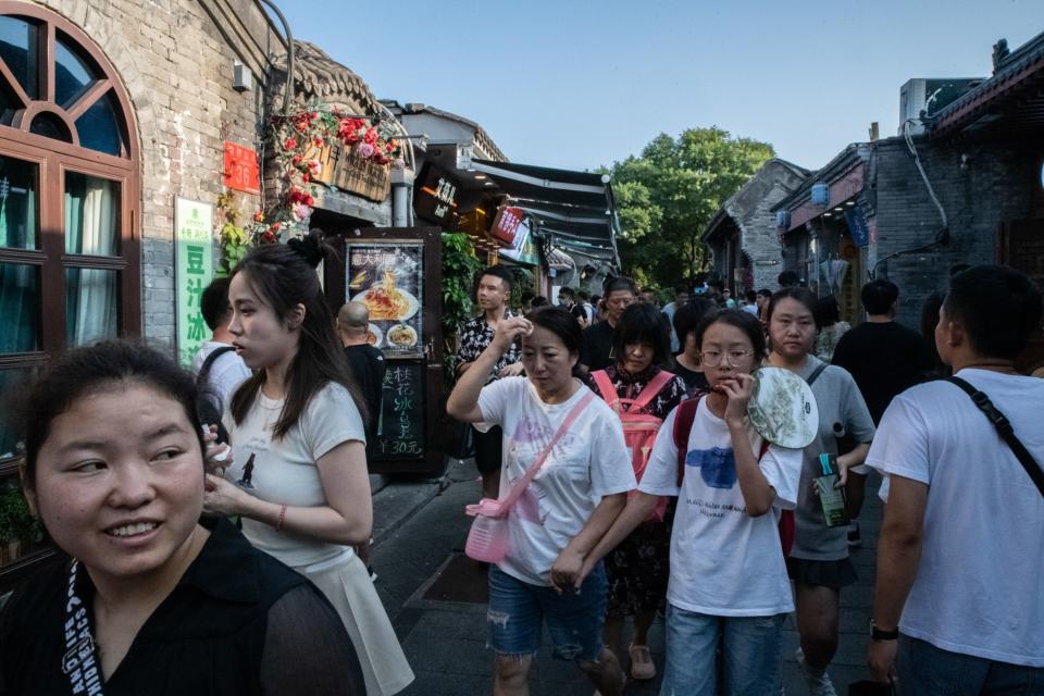 Visitors in Nanluoguxiang, an alleyway popular with tourists, in Beijing. Source: Bloomberg