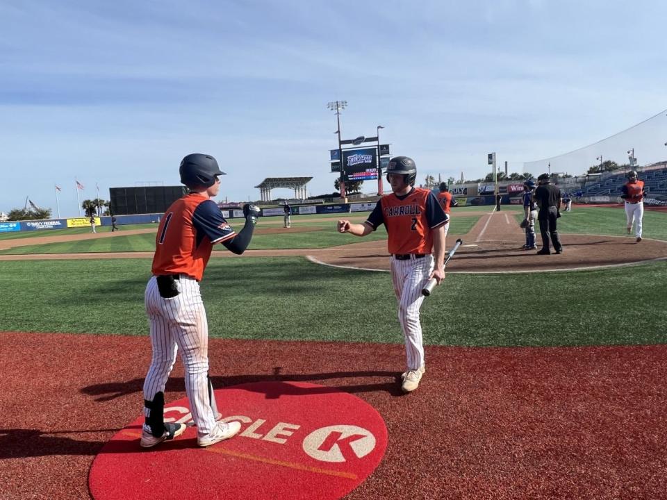 Carroll University celebrates a run scored during Tuesday's first game of the Studer's Blue Wahoos Challenge.