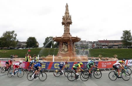 2018 European Championships - Road Cycling, Road Race Women - Glasgow, Britain - August 5, 2018 - Cyclists ride past Doulton Fountain in Glasgow Green. REUTERS/Peter Cziborra