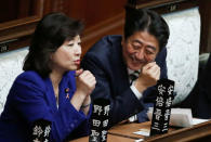 Japan's Prime Minister Shinzo Abe (R) laughs as he talks with ruling Liberal Democratic Party lawmaker Seiko Noda at the Lower House of the Parliament in Tokyo, Japan, November 1, 2017. REUTERS/Toru Hanai