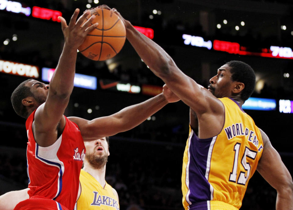 Los Angeles Clippers' Chris Paul, left, has his shot blocked by Los Angeles Lakers' Metta World Peace, right, during the first half of an NBA preseason basketball game in Los Angeles on Monday, Dec. 19, 2010. (AP Photo/Danny Moloshok)