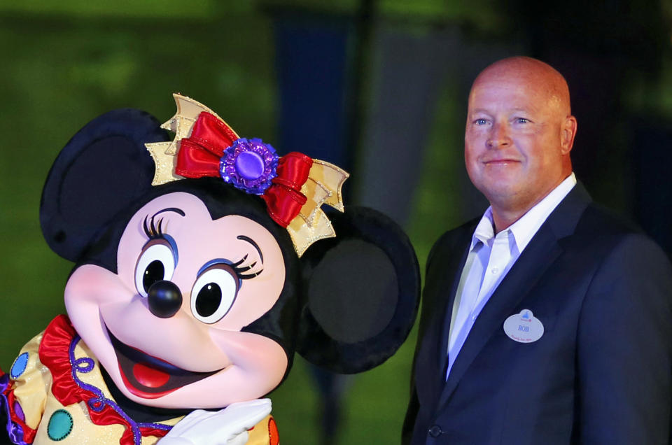 FILE - Chairman of Walt Disney Parks and Resorts Bob Chapek poses with Minnie Mouse during a ceremony at the Hong Kong Disneyland, as they celebrate the Hong Kong Disneyland's 10th anniversary on Sept. 11, 2015. The Walt Disney Company announced late Sunday, Nov. 20, 2022, that former CEO Bob Iger will return to head the company for two years in a move that stunned the entertainment industry. Disney said in a statement that Chapek, who succeeded Iger in 2020, had stepped down from the position. (AP Photo/Kin Cheung, File)