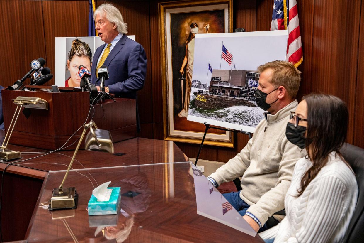 Attorney Geoffrey Fieger, left, speaks to the news media as Jeffrey and Brandi Franz, parents of Riley and Bella Franz, look on as Fieger announces a federal lawsuit against the Oxford School District at his office in Southfield on Thursday, Dec. 9, 2021.