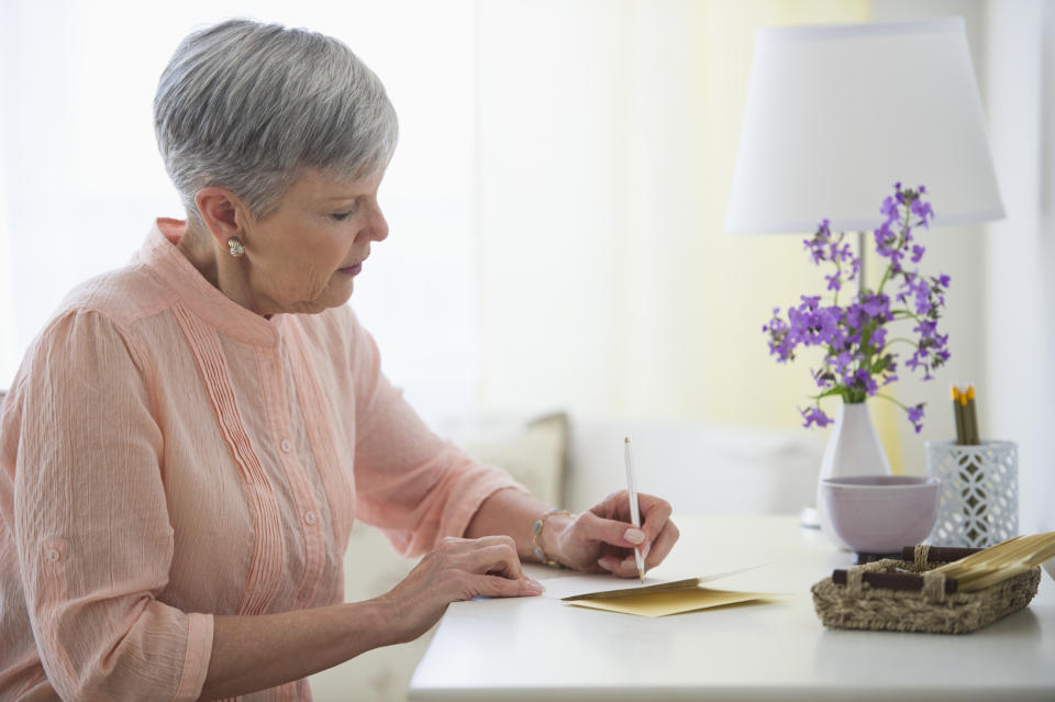 woman writing at desk